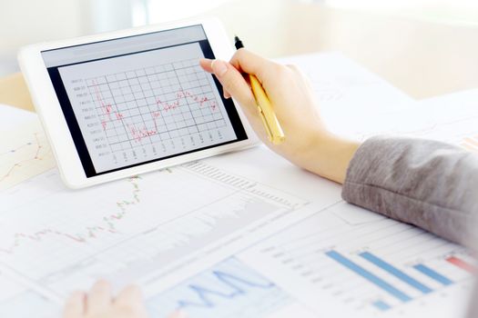 Close up hand holding digital tablet with analyzing graph,planing,business success