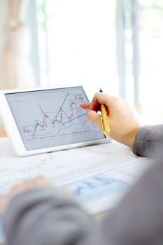 Close-up Of Businesswoman Analyzing Graph On Digital Tablet 
