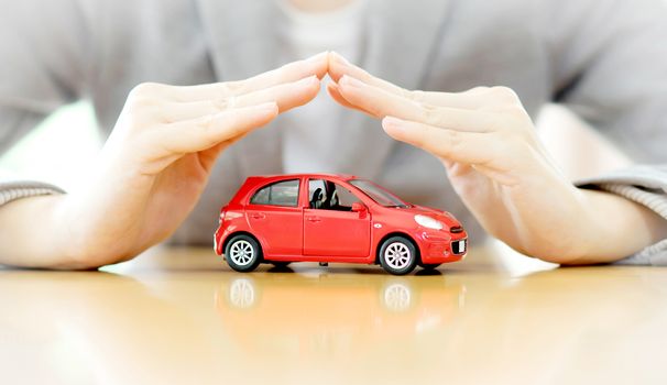 Businesswoman hands and car as protection of car concept