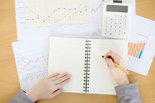 picture of woman hand with calculator and papers