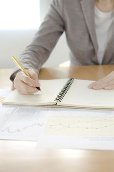 picture of woman hand with calculator and papers