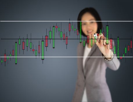 Young beautiful businesswoman drawing a graph