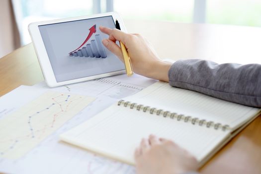 Close-up Of Businesswoman Analyzing Graph On Digital Tablet