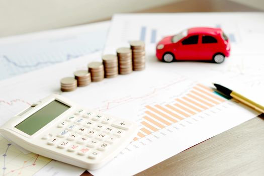  With Car Model And Stack Of Coins On Desk