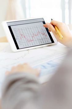 Close up hand holding digital tablet with analyzing graph,planing,business success