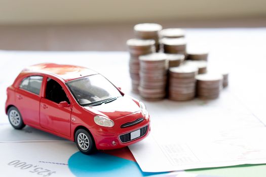 Car model and Financial statement with coins. (finance and car loan concept)