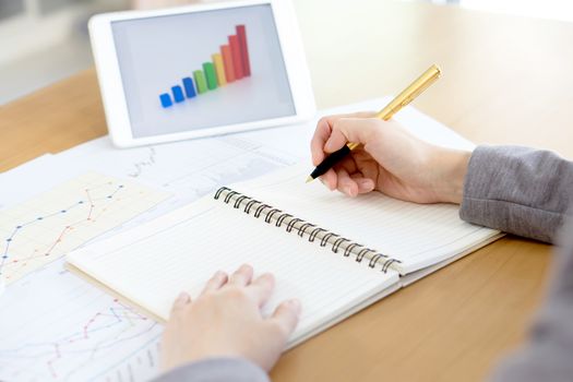 business woman analysis with financial graph at office, workplace
