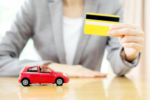 Real estate investment by credit card. Car on table.