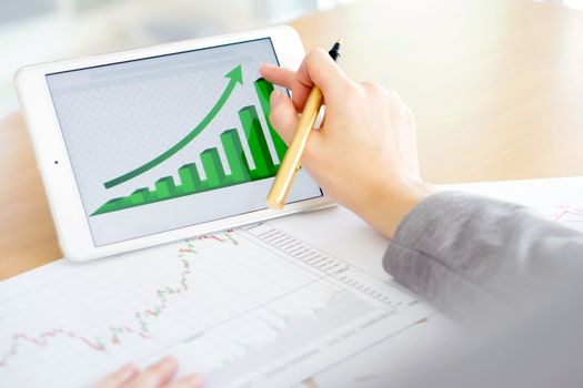 Hand on screen tablet pc with business information