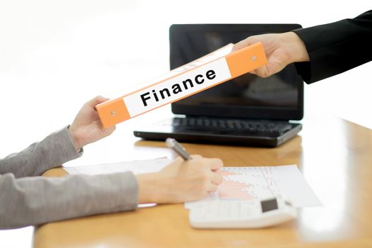 Businesswoman sends the finance document to the businessman. selective focus.