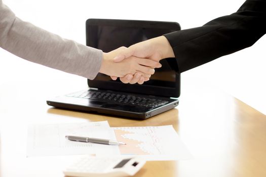 Two Businesspeople shaking hands indoors