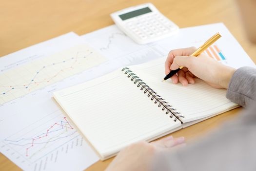 picture of woman hand with calculator and papers