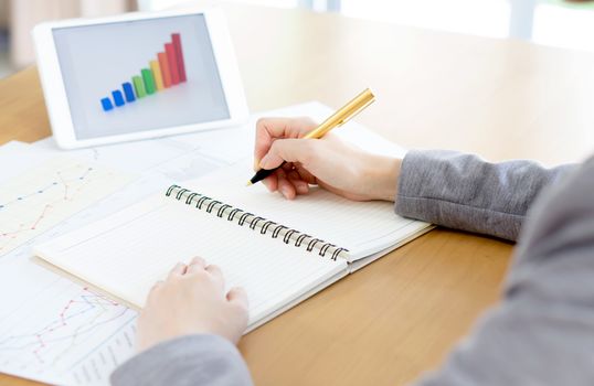 business woman analysis with financial graph at office, workplace
