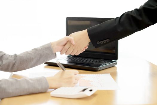 Two Businesspeople shaking hands indoors