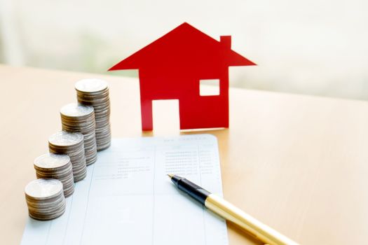 money, coins stack in columns with saving book and paper home,concept