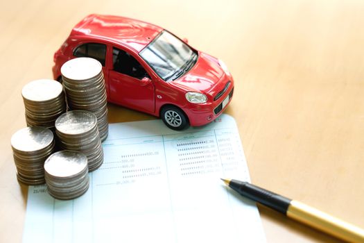 Coins stack in columns, saving book, car. Finance and banking concept.