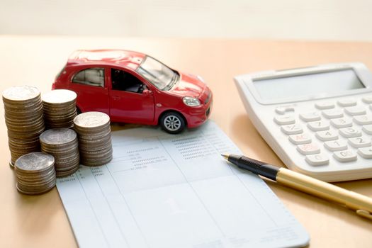 Coins stack in columns, saving book, car. Finance and banking concept.