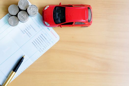 Coins stack in columns, saving book, car. Finance and banking concept.