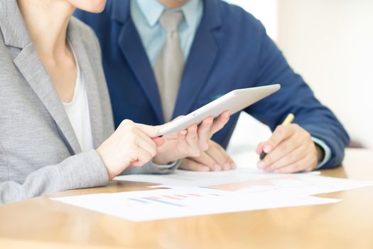 Image of two young business partners discussing plans or ideas at meeting