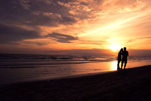 Couple Walking by the Ocean Shoreline