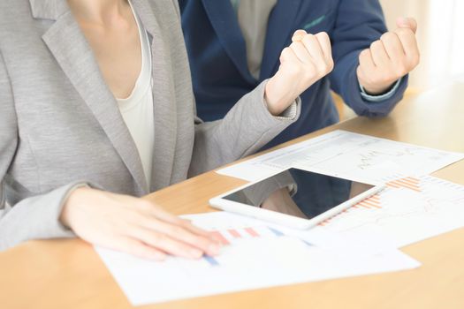 Successful two colleagues are expressing positive emotions