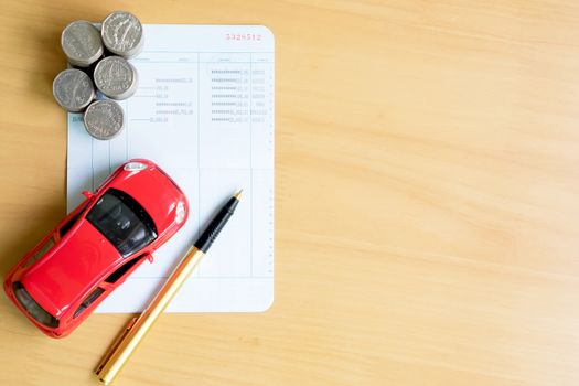 Coins stack in columns, saving book, car. Finance and banking concept.