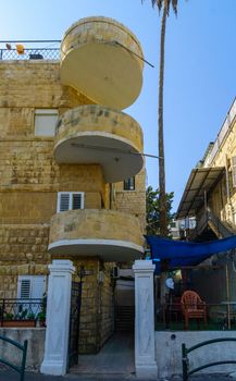 HAIFA, ISRAEL - OCTOBER 27, 2017: Historical houses in mixed Arab and International (Bauhaus) style, with locals and visitors, in Haifa, Israel