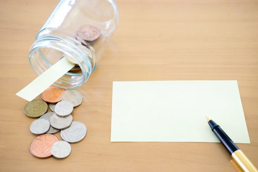 Money jar with U.S. currency represents savings, donations concepts.