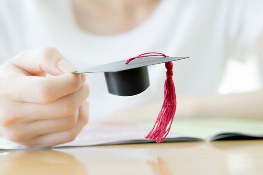 woman hand  hold graduation cap, conception