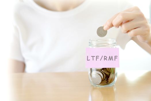 Woman hands with coins in glass jar, close up