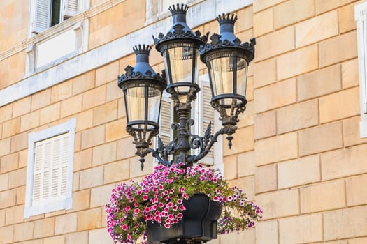 typical street lighting in the center of barcelona, spain with its spanish escutcheons