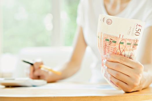 Businesswoman using calculator 