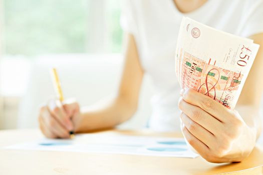 Businesswoman using calculator 