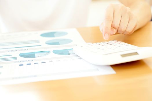 Businesswoman analyze year plan with calculator 