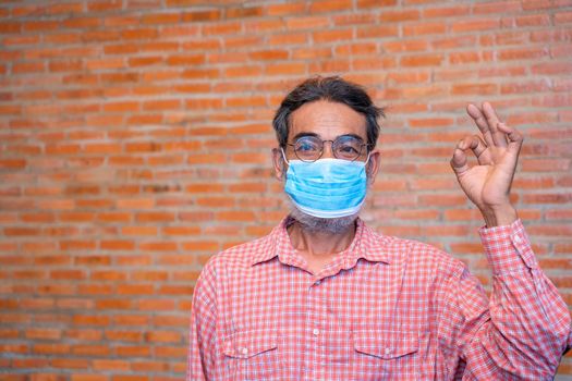 Elderly man wears protective mask against infectious diseases and flu,Concept of recommendations for protection against the virus.