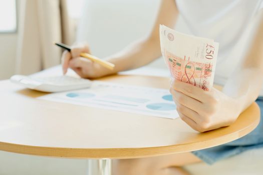 Businesswoman using calculator 