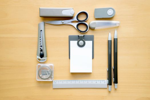 Open album with school supplies on the wooden table 