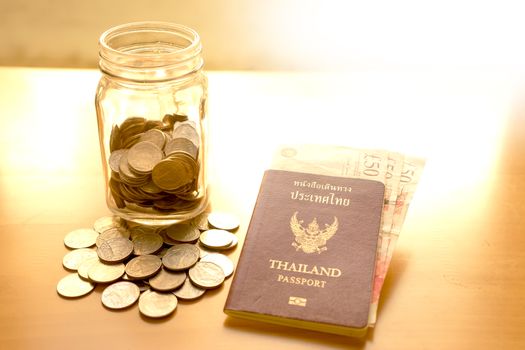 Savings jar with currency for travel 