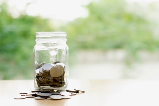 Savings word with money coin in glass jar.financial concept 