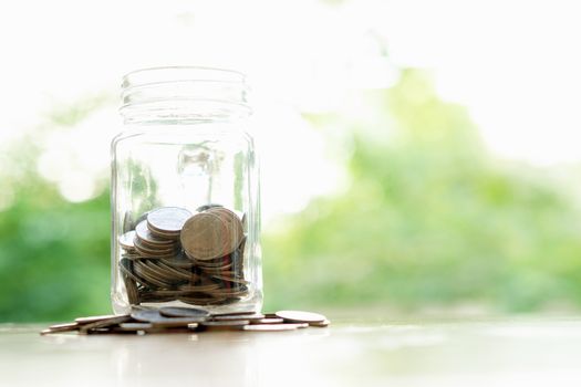Savings word with money coin in glass jar.financial concept 