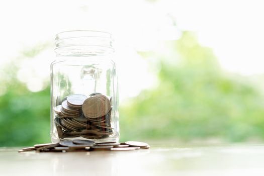 Savings word with money coin in glass jar.financial concept 