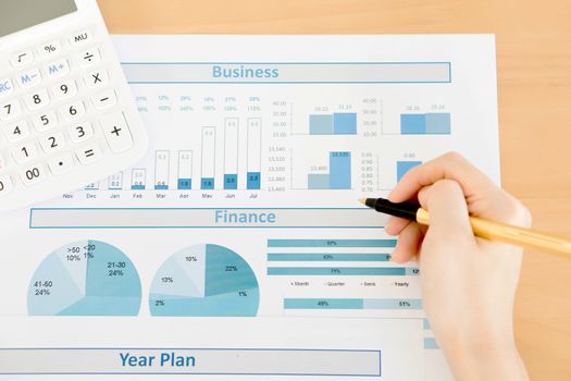 Businesswoman analyze year plan with calculator 