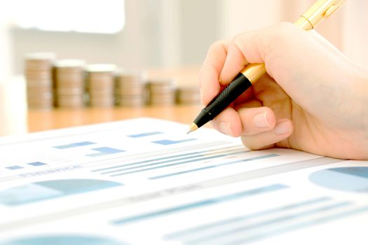 Businesswoman Analyzing Financial Graph With Coins 