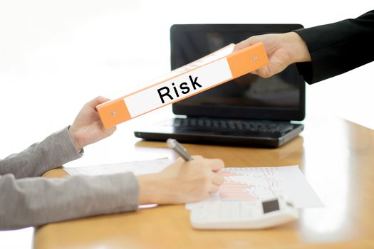 Businesswoman sends the debtor document to the businessman. selective focus.