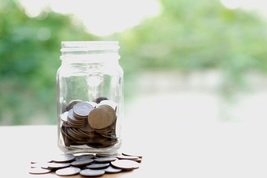 Savings word with money coin in glass jar.financial concept 