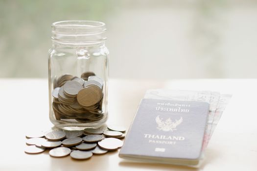 Savings jar with currency for travel