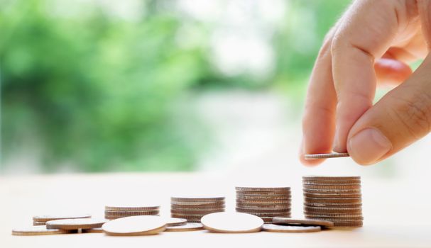 hand put money coins to stack of coins. Money, Financial, Business Growth concept.