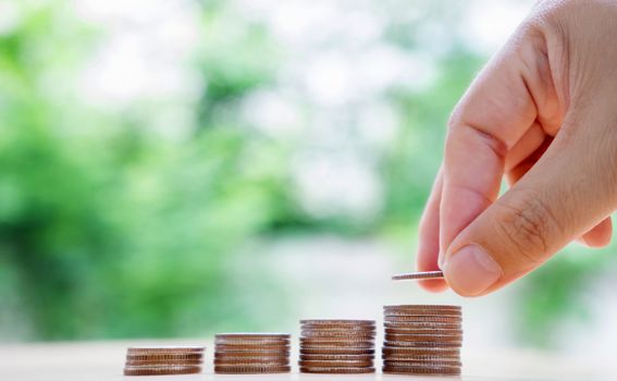 hand put money coins to stack of coins. Money, Financial, Business Growth concept.