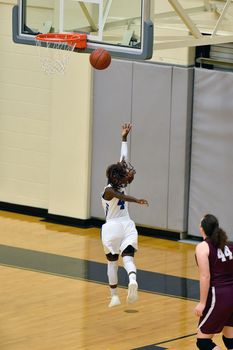 Girl shooting a basketball lay up with the caption: "My Game"