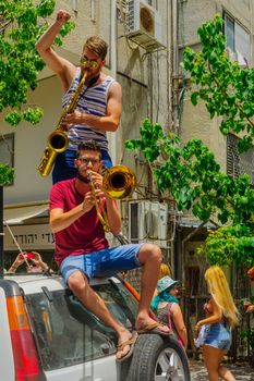 TEL-AVIV, ISRAEL - JUNE 03, 2016: People play music, as part of the Pride Parade in the streets of Tel-Aviv, Israel. Its part of an annual event of the LGBT community